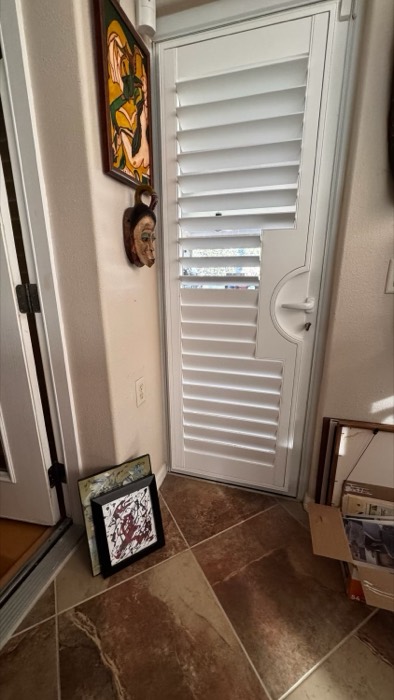 Plantation shutter fitted to a back door with a round handle cutout