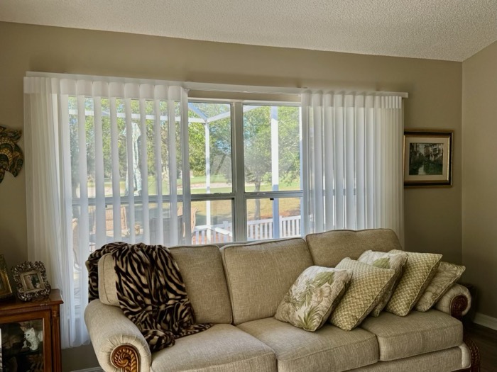 Wave sheer drapery over sliding glass doors in a living room