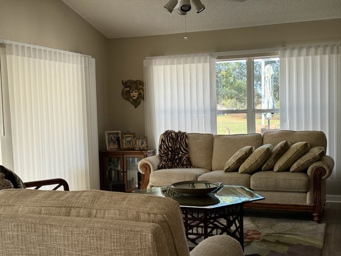Half-round transom plantation shutter above a front door with sidelight
